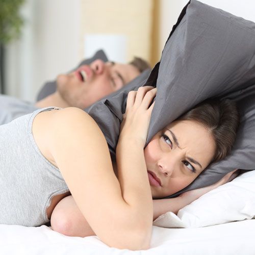 Woman trying to sleep through husband&rsquo;s snoring