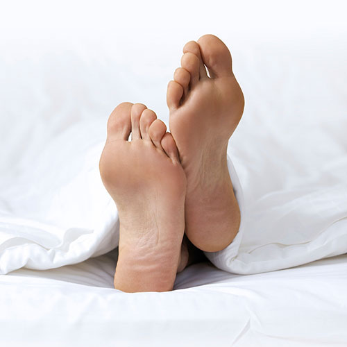Man&rsquo;s feet whilst asleep in bed